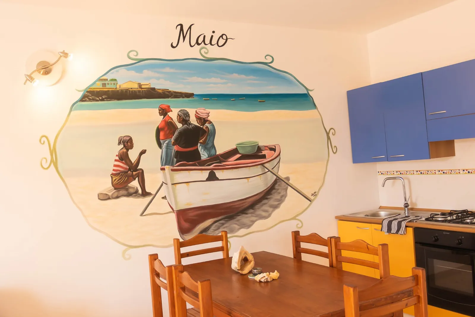 Maio — hand-painted Maio mural beside the kitchen