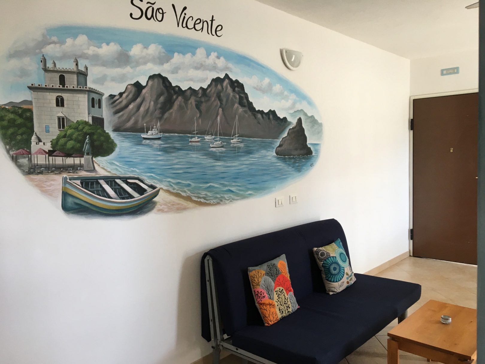 São Vicente — hand-painted São Vicente mural above the sofa