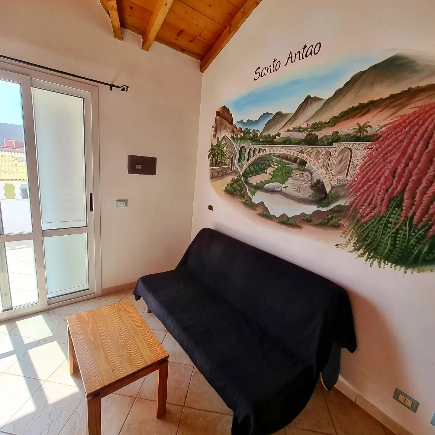 Santo Antão — sofa lounge with Santo Antão mural