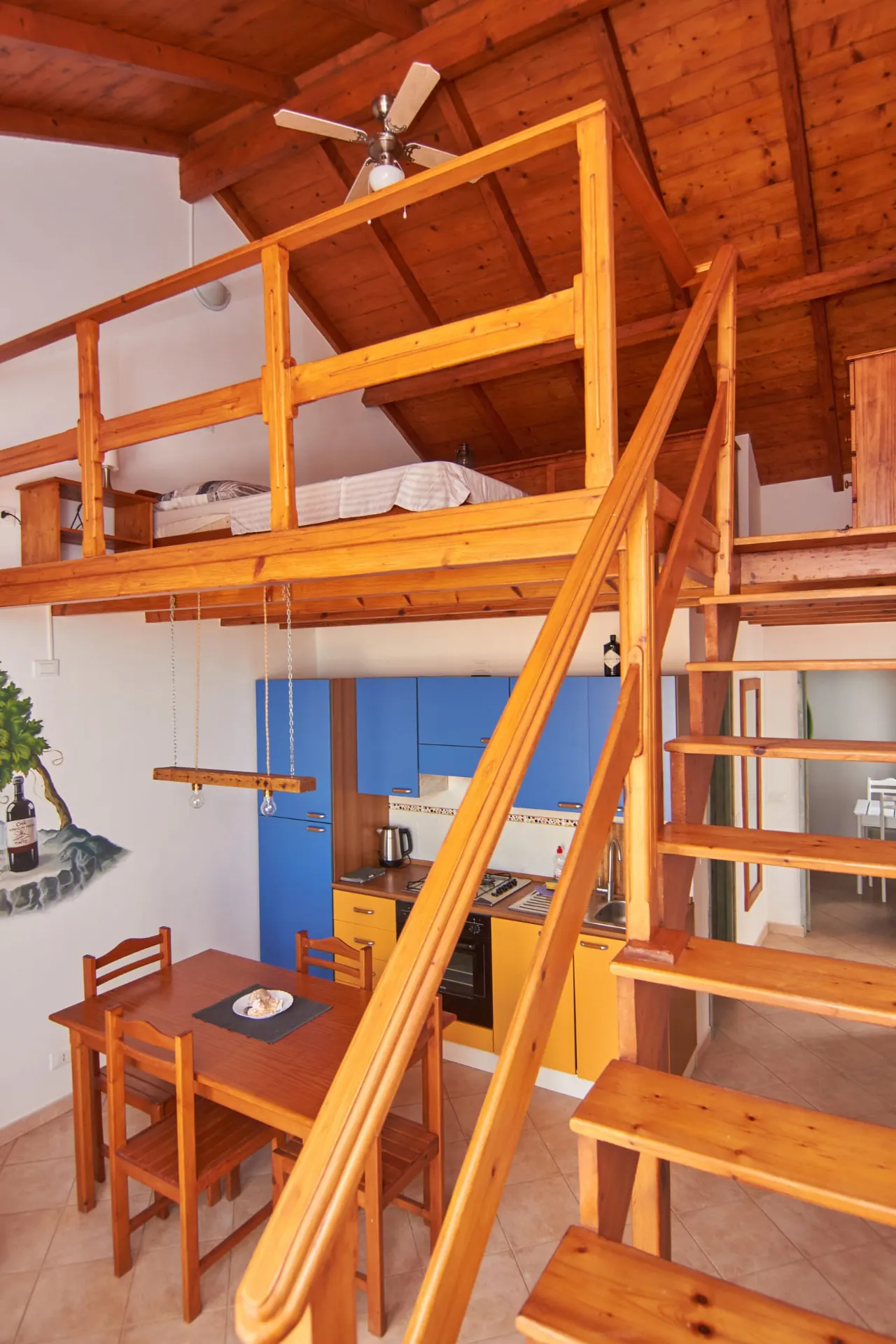 Fogo — wooden stairs to the mezzanine bedroom
