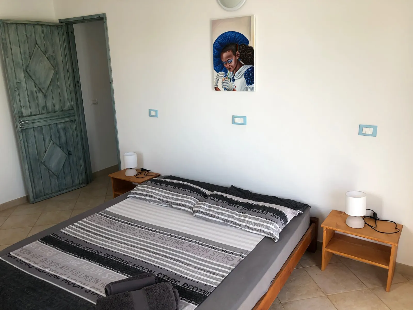 São Vicente — double bedroom with local artwork